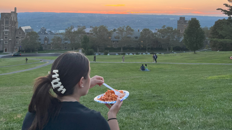 A student enjoys a meal on Libe Slope.